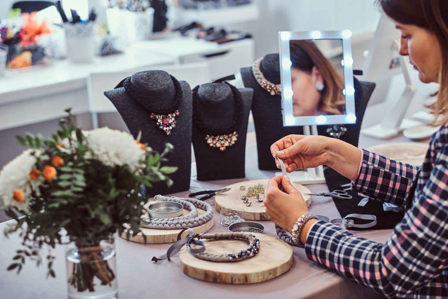 elegantly-dressed-woman-makes-handmade-necklaces-working-with-needles-thread-jewelry-workshop (1)